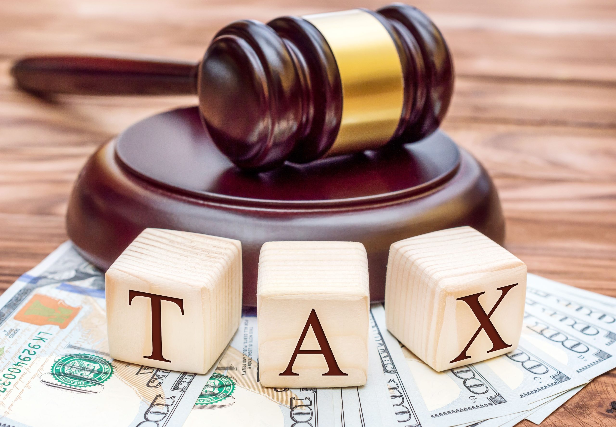 Tax law concept. Word " TAX " with gavel and money on the table.