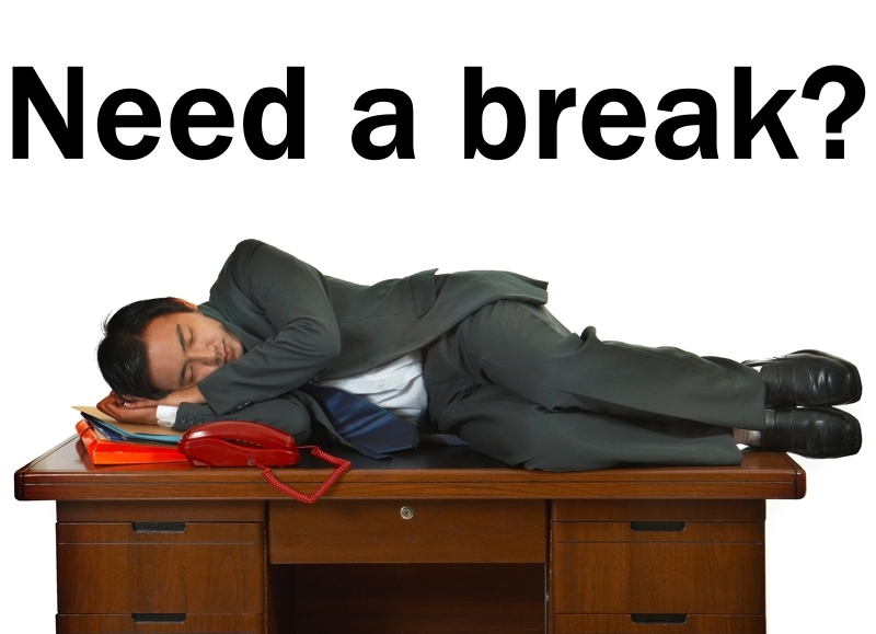 Tired Businessman Having A Sleep On A Desk In His Office